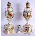 A PAIR OF LATE 19TH CENTURY GERMAN DRESDEN PORCELAIN VASES AND COVERS painted with landscapes. 47 cm