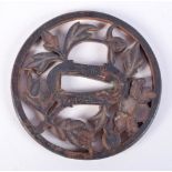 A JAPANESE IRON TSUBA, SIGNED/ 7.6cm diameter, weight 108.1g