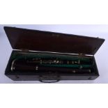 A LOVELY ANTIQUE CARVED WOOD CLARINET within a George III wood case. 66 cm long.