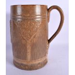 A RARE LARGE ROYAL DOULTON STONEWARE ALE JUG decorated with bacchus mask heads. 24 cm x 12 cm.