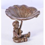 A JAPANESE BRONZ OF A SEATED BOY HOLDING ALOFT A LILLY PAD. 6.1cm x 6.3cm, weight 126.7g