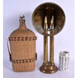 AN UNUSUAL BRASS LAMP and a wicker bottle. Largest 41 cm high. (2)