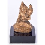 A small gilt bronze Buddha mounted on a plinth 6 cm.