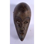 AN AFRICAN TRIBAL CARVED WOOD MASK. 30 cm x 15 cm.