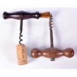 A 19th century corkscrew with brush together with another wooden handled corkscrew (2)