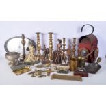 A large collection of brass and metal items including candle sticks, door stops, road lamps, figures