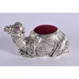 A PIN CUSHION IN THE FORM OF A SEATED CAMEL. 2.8cm x 5.3cm x 2.4cm, weight 44.8g
