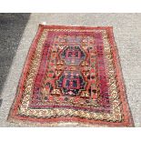 A Persian red ground Tribal Rug 200 x 136 cm.