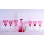 A LARGE VINTAGE CRANBERRY GLASS DECANTER with six glasses. Largest 41 cm high. (7)