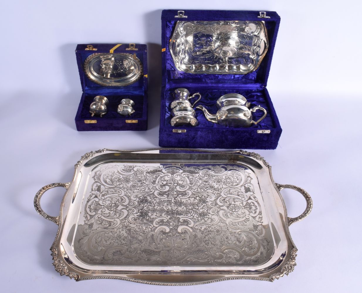 A LARGE SILVER PLATED TRAY together with two boxed sets. Largest 52 cm x 34 cm.