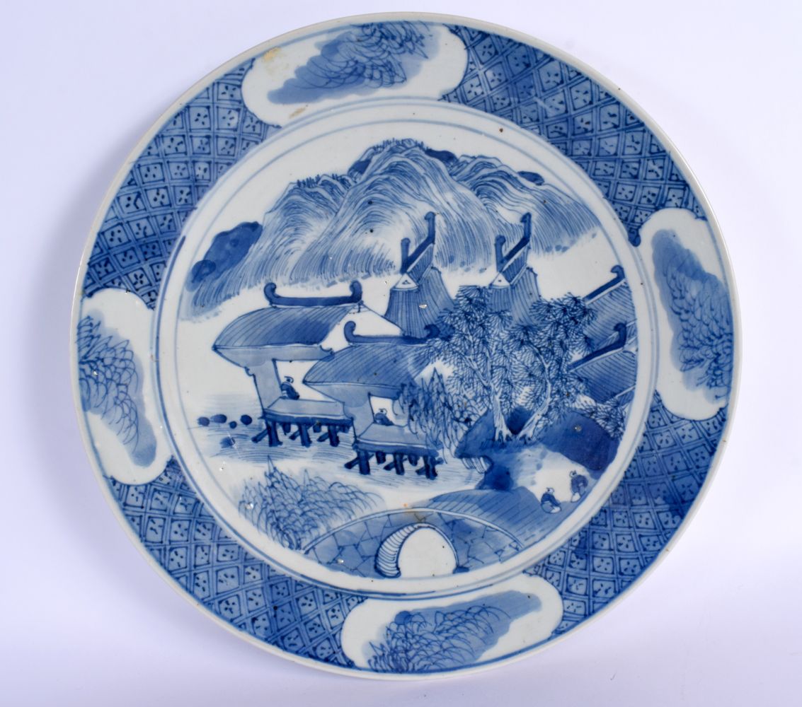 A LARGE 19TH CENTURY CHINESE BLUE AND WHITE PORCELAIN DISH Qing, painted with landscapes. 28.5 cm di