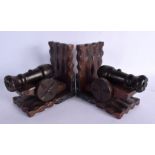 AN UNUSUAL PAIR OF MILITARY CANNON CARVED WOOD BOOK ENDS. 17 cm x 15 cm.