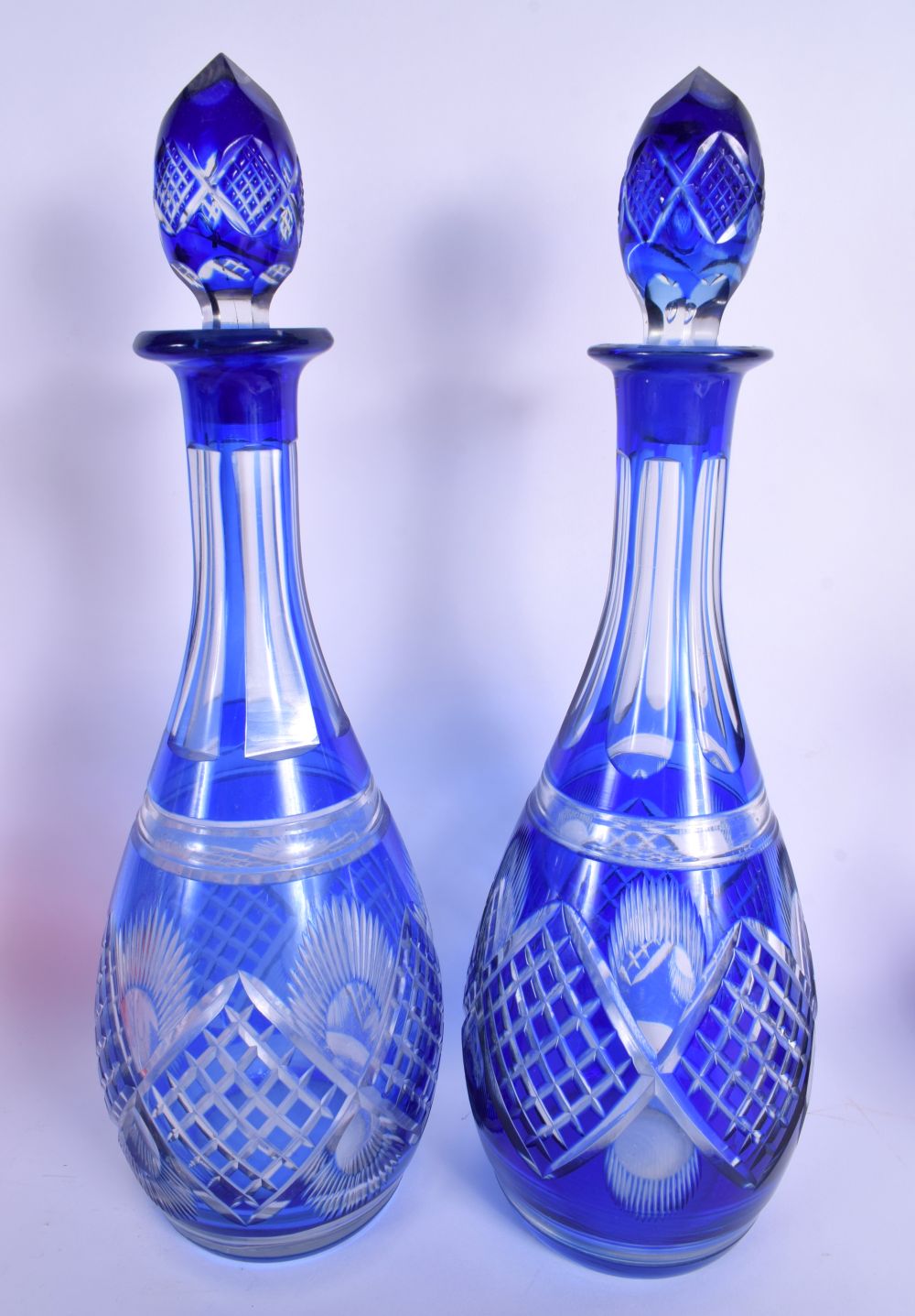 A PAIR OF BOHEMIAN BLUE FLASH DECANTERS with stoppers, together with a vase & bells. Largest 34 cm h - Bild 2 aus 7