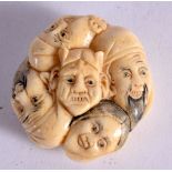 A JAPANESE BONE NETSUKE CARVED WITH FACS. 4cm x 1.6cm, weight 23.5g