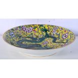A Chinese porcelain Famille jaune dish decorated with dragons and foliage 5 x 21cm.
