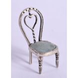 A SILVER MINIATURE CHAIR. 4.6cm x 2.2cm x 1.9cm