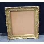 A large wood and gilded plaster picture frame 97 x 87 cm.