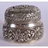 AN EMBOSSED WHITE METAL DRESSING TABLE BOX. 8.3cm diameter, 6cm high, weight 157g