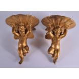 A PAIR OF EARLY 20TH CENTURY CARVED GILTWOOD CHERUB HANGING FIGURES. 13 cm x 8 cm.
