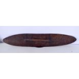 AN AUSTRALIAN TRIBAL ABORIGINAL CARVED WOOD PARRYING SHIELD. 57 cm long.