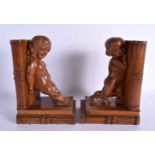 A PAIR OF 1930S CARVED OAK FIGURAL BOOK ENDS. 21 cm x 14 cm.