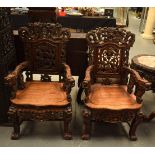 A LARGE PAIR OF 19TH CENTURY CHINESE CARVED HONGMU ARM CHAIRS decorated with dragons. 105 cm x 52 cm