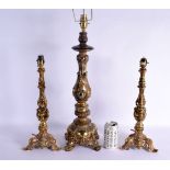 THREE EUROPEAN GILT METAL CANDLESTICKS converted to lamps, smothered in acanthus. Largest 70 cm high