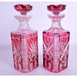 A PAIR OF BOHEMIAN RUBY FLASH DECANTERS AND STOPPERS with star curt decoration. 25 cm x 8 cm.