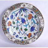 A TURKISH MIDDLE EASTERN FAIENCE IZNIK PLATE painted with foliage. 29 cm diameter.