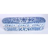 A Chinese porcelain blue and white pen box decorated with foliage 8 x 32 x 8cm.