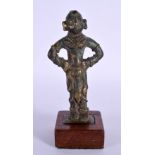 A 17TH/18TH CENTURY INDIAN BRONZE FIGURE OF A BUDDHISTIC DEITY modelled with hands upon his hips. 15