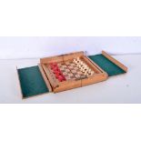 A cased portable bone chess set 3 x 17 cm.
