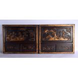 A PAIR OF 19TH CENTURY CHINESE CARVED AND LACQUERED WOOD PANELS depicting figures within landscapes.