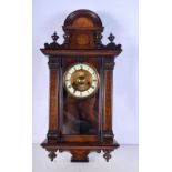 A wall clock with a wooden case decorated with a painted floral pattern .62 x 31cm