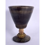 A RARE 18TH/19TH CENTURY GERMAN CARVED RHINOCEROS HORN BEAKER with dimpled bronze mounts. 179 grams.