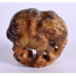 A CHINESE JADE ROUNDEL CARVED AS A BEAST WITH A MONKEY ON HIS BACK. 4.8cm diameter, weight 57g