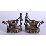 A PAIR OF CONTINENTAL SILVER FIGURAL TABLE SALTS. 6.2cm x 7.3cm x 4.3cm, total weight 149g (2)