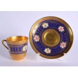 LATE 19TH/EARLY 20TH CENTURY CAULDON CUP AND SAUCER HEAVILY GILDED WITH ACID ETCHED BORDERS, THE BLU
