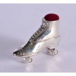 A STERLING SILVER PIN CUSHION IN THE FORM OF A ROLLER SKATE. Stamped Sterling. 3cm x 3.6cm x 1.2cm,