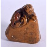 A SOAPSTONE SEAL CARVED AS A DRAGON ON A ROCK. 6.2cm x 5.6cm x 4.5cm