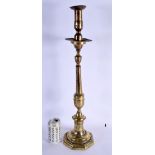 A LARGE 18TH CENTURY CONTINENTAL BRASS ALTAR TYPE CANDLESTICK. 64 cm high.