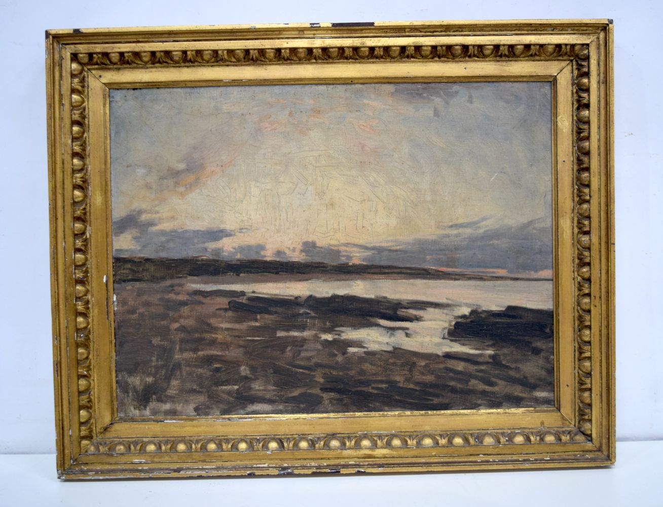 A framed oil on board of a coastal scene. 44 x 58cm.