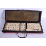 AN EARLY 20TH CENTURY CHINESE CARVED BONE MAHJONG SET within a lacquered box. 42 cm x 14 cm.