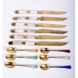 A SET OF SIX SILVER AND ENAMEL SPOONS together with six silver gilt bladed knifes. (12)