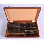 A CASED SET OF EIGHT ANTIQUE RHINOCEROS HORN KNIVES. (8)