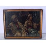 A framed oil on board of a middle Eastern couple signed Khaild 28 x 38cm.