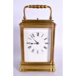 AN ANTIQUE FRENCH REPEATING BRASS CARRIAGE CLOCK. 17 cm high inc handle.