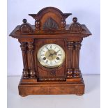 A wooden framed mantle clock with an enamelled metal clock face 39 x 41 cm