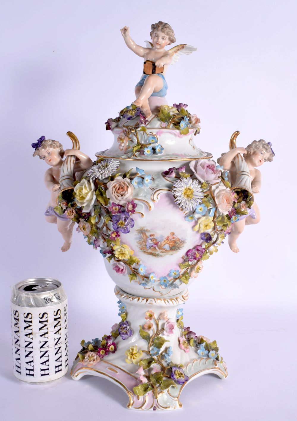 A LARGE EARLY 20TH CENTURY GERMAN PORCELAIN VASE AND COVER with figural cherub supports. 42 cm x 24