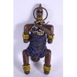 AN AFRICAN CARVED WOOD BEADED TRIBAL FIGURE. 18 cm x 8 cm.